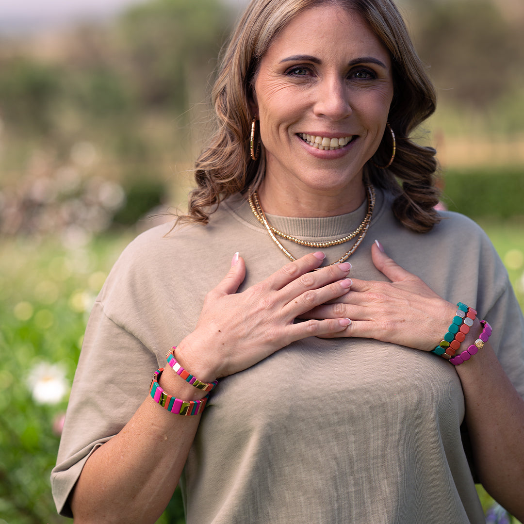 A lady wearing, earings, bracelets and  necklaces fom Leigh Avenue