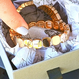 Gold custom engraved bracelet with personalised name bead.