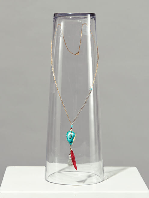 turquoise nugget feather and tassel on gold chain with crystal beads lifestyle