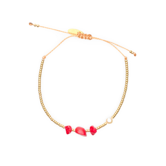 A Walk in the Park Bracelet features three organic-shaped red stones offset by a classic pearl. 