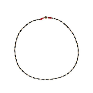 Black and gold collide in a river of gorgeous harmony in this tribal-inspired necklace.