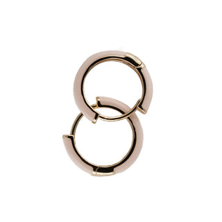 Elegant white resin hoop earrings with a polished gold-tone interior, combining timeless style with a contemporary finish.