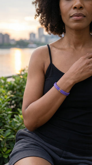 Elegant evening styling featuring a vibrant purple resin bracelet with subtle gold detailing.