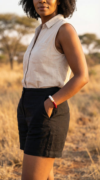 A stylish woman wearing a two-tone burgundy and white resin bracelet, bringing a sophisticated touch of colour to a relaxed outdoor look.