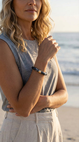 A woman wearing a sparkling gold resin bracelet that adds a radiant finishing touch to an elegant evening outfit, effortlessly blending glamour with modern sophistication.
