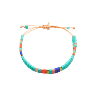 Colourful adjustable beaded bracelet featuring vibrant turquoise tile beads accented with coral, cobalt blue, blush pink, and polished gold details for a fresh, modern look.