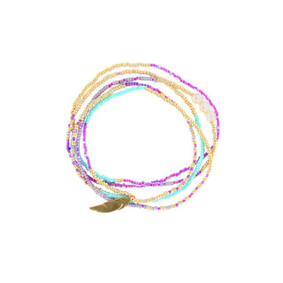 Multi-strand beaded necklace featuring turquoise, lilac, fuchsia, and polished gold beads with freshwater pearl accents and a gold feather pendant for a vibrant layered statement.