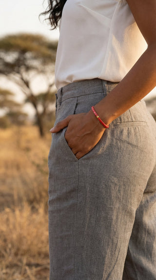 A woman wearing a slim pink tile beaded bracelet with a gold accent, adding a soft pop of colour to a relaxed outfit with effortless everyday elegance.